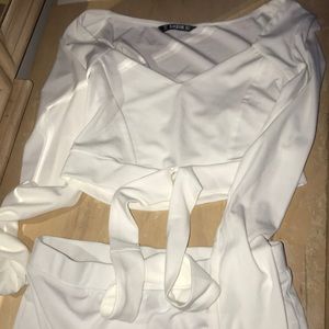 a white crop top with long sleeves and skirt set